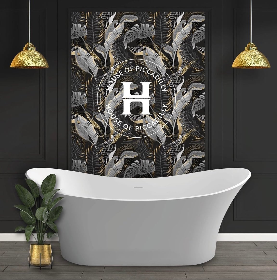 White bathtub, Infront of a leafy wall paper with the House of Piccadilly logo on. Gold lights hanging down either side of the bath and a green leafy plant potted in a gold pot.