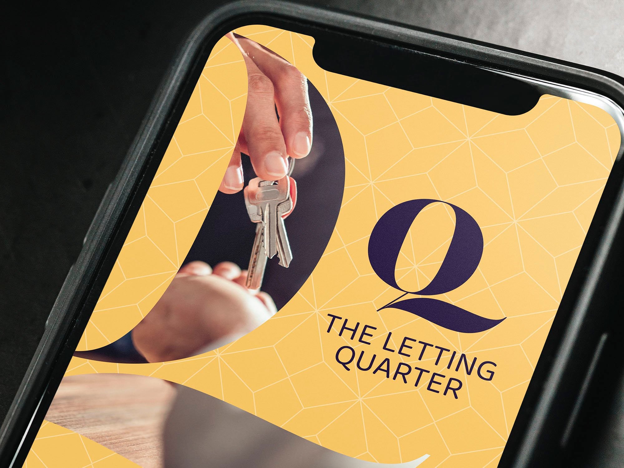 A mobile phone displaying The Letting Quarter website on the screen