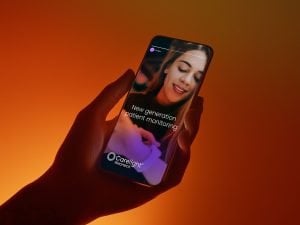 A hand holding a mobile device displaying Carelight social media story.